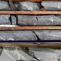 Examples of sulfide stockwork feeder mineralization encountered in recent drilling at Jeff target. Gold colors are pyrite. Fine grains of tetrahedrite, a silver sulfosalt mineral, occurs interstitial to pyrite in the upper photo. Bright red spots in the lower photos are pyrargyrite, also a silver sulfosalt mineral.